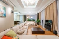 Sebuah ruang keluarga modern yang ditata dengan prinsip feng shui, menampilkan keseimbangan warna, tekstur, dan penempatan furnitur untuk menciptakan suasana harmonis serta aliran energi positif yang menyejukkan. Penempatan tanaman hidup dan pencahayaan alami mendukung kualitas chi yang optimal di dalam ruangan.